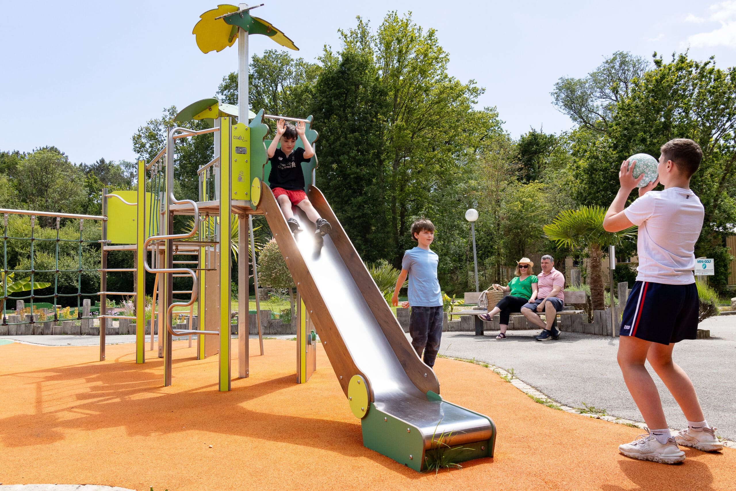 Famille qui joue dans une aire de jeu pour enfants 